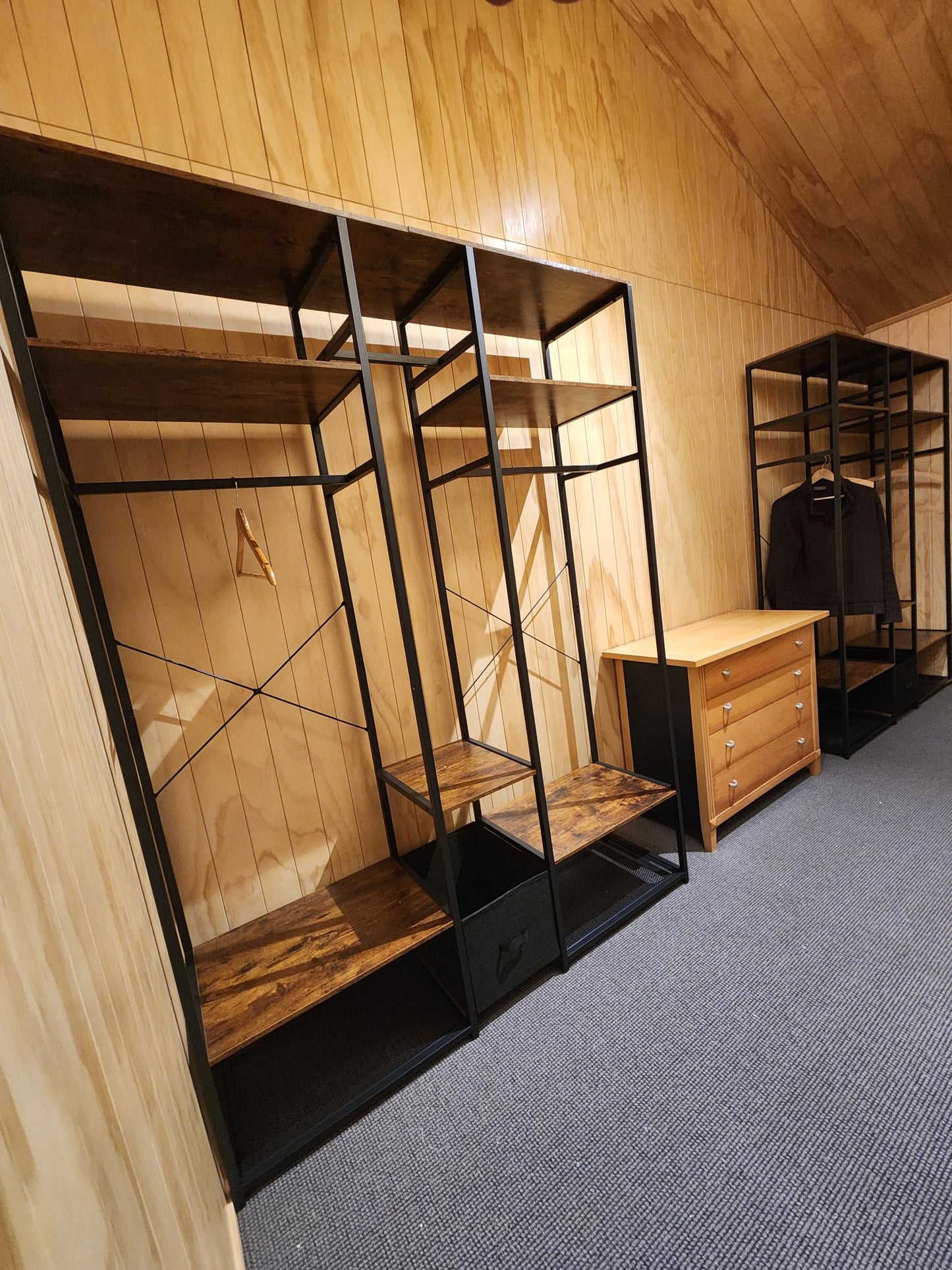 Clothes rack in bedroom setting with hanging garments
