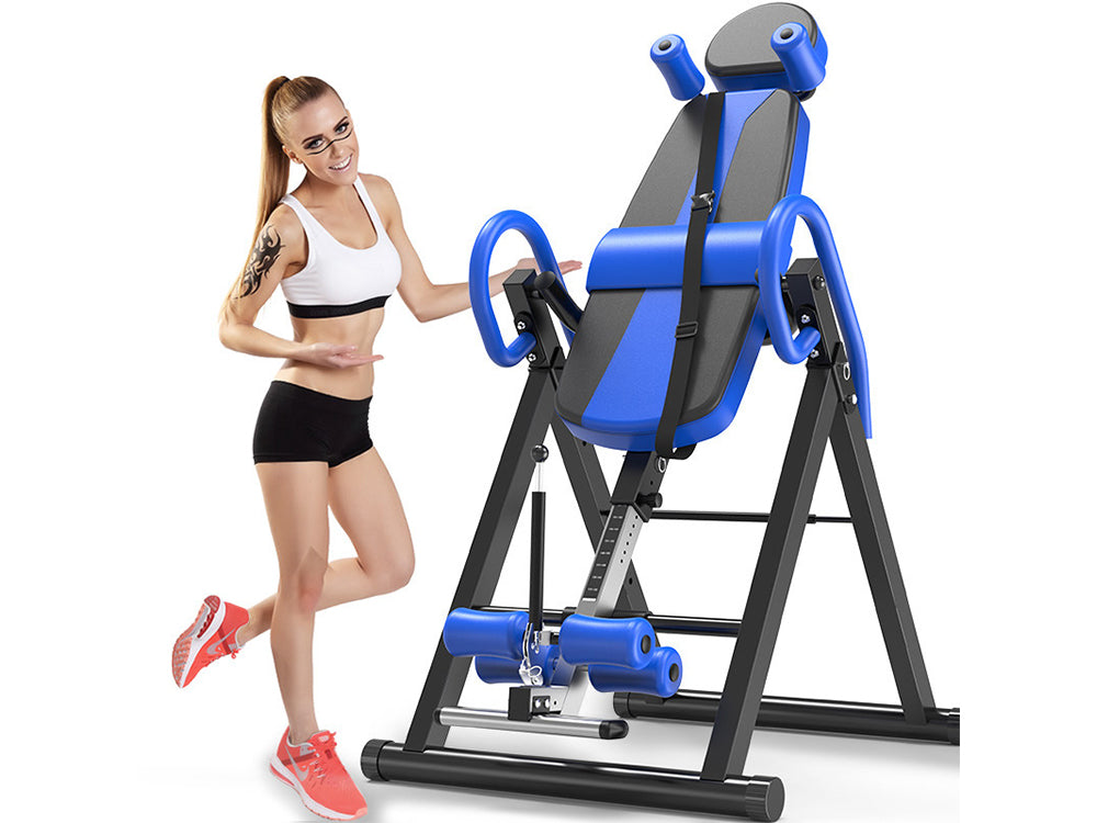User standing upside down on inversion table for back stretch