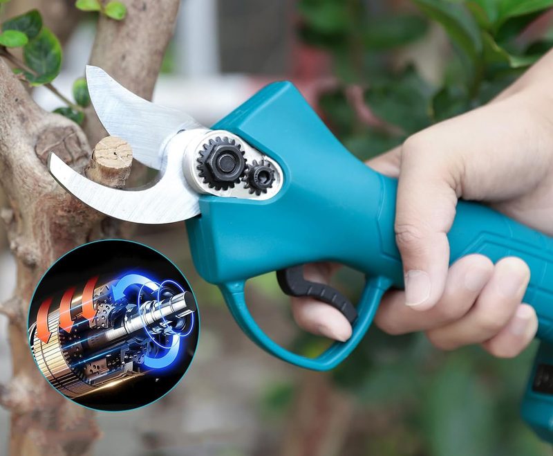 Electric branch scissors held in one hand showing compact size