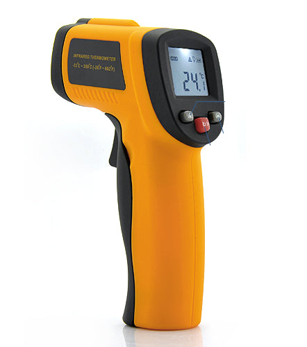 Infrared thermometer held over cooking surface in kitchen
