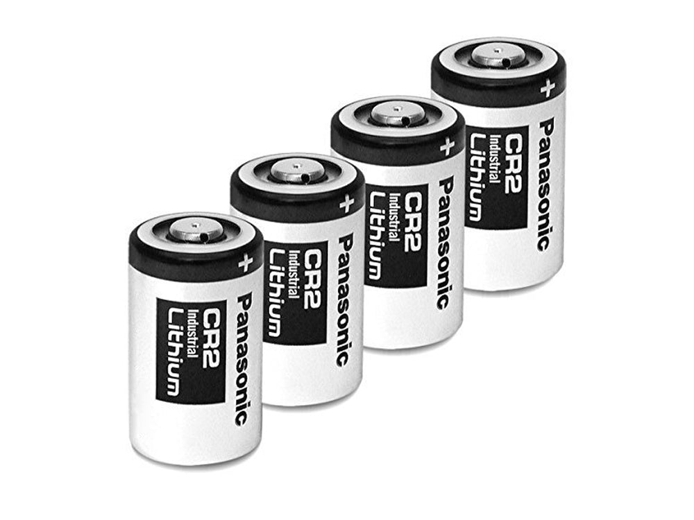 CR2 battery in hand showing compact size