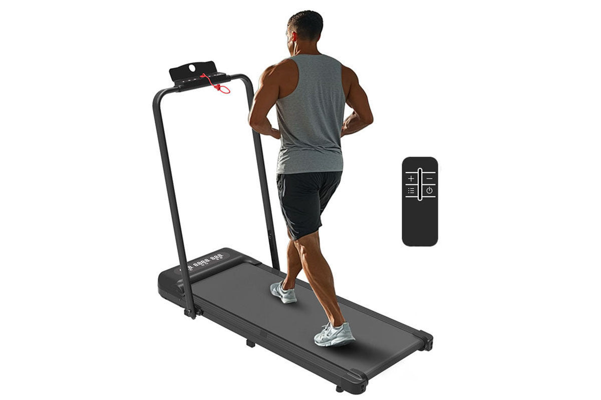 User walking on treadmill exercise machine in home office setting