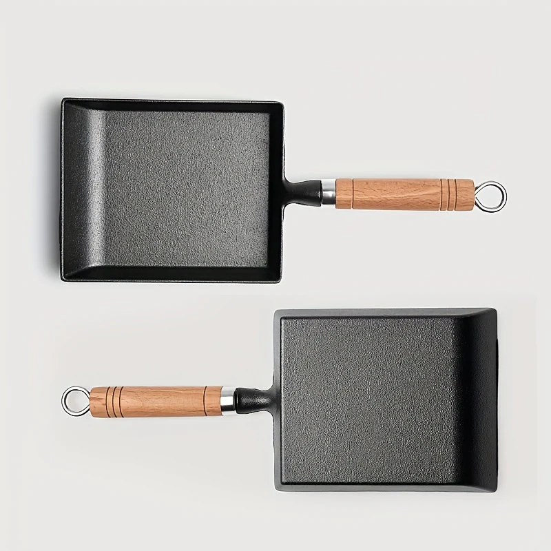 Square 18CM cast iron frying pan placed on outdoor fire setup