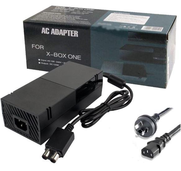 Xbox One power supply charger resting on a wooden surface