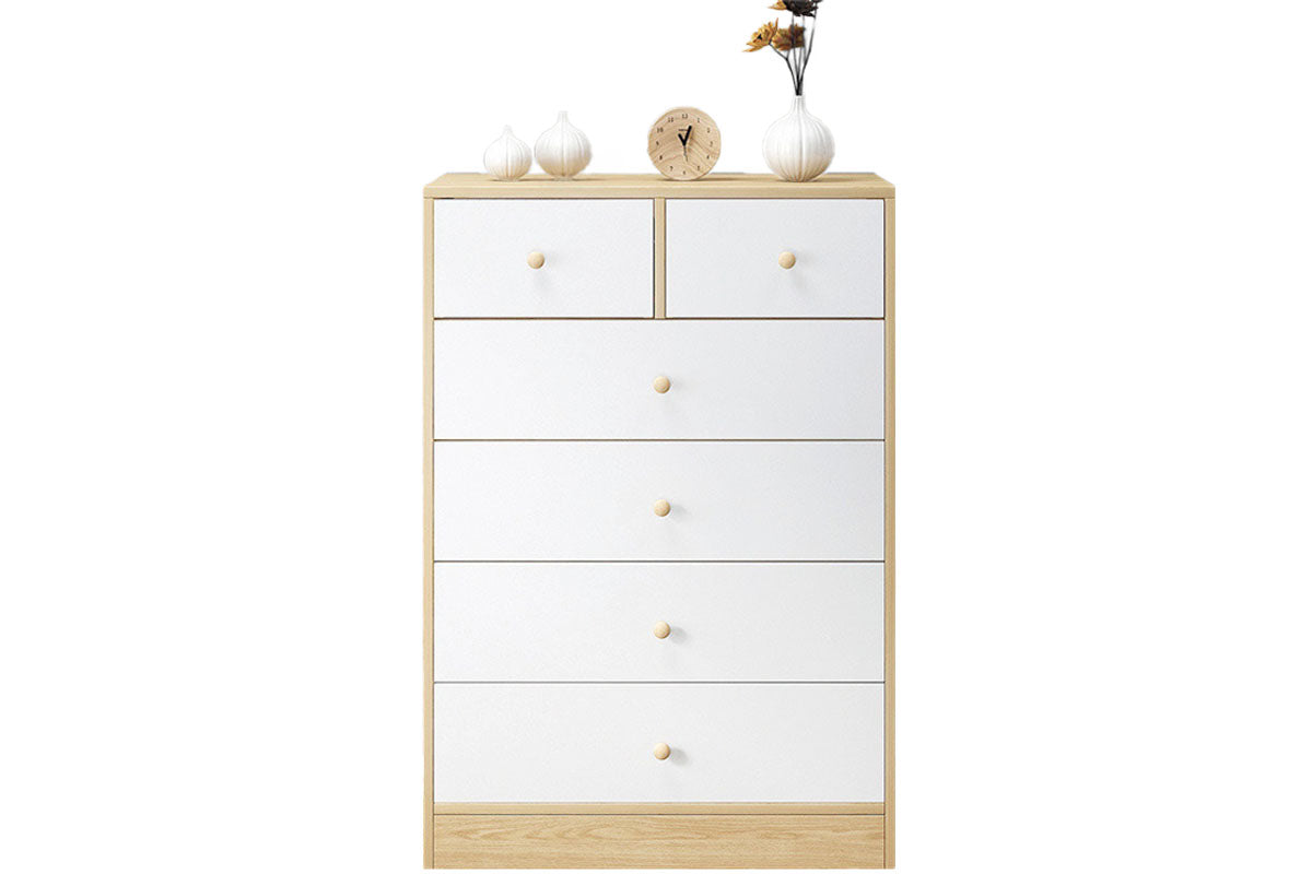 Tallboy chest of drawers next to bed in white colour