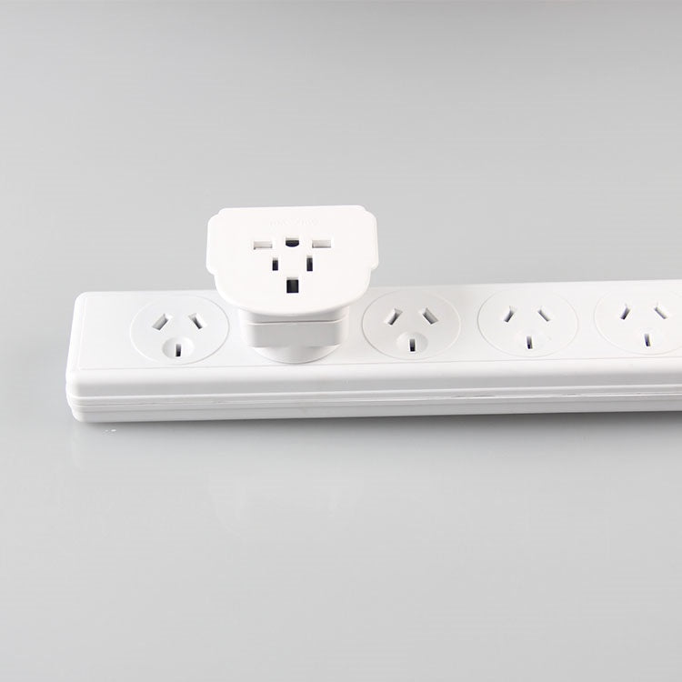 Travel adapter with NZ plug plugged into a power socket in New Zealand