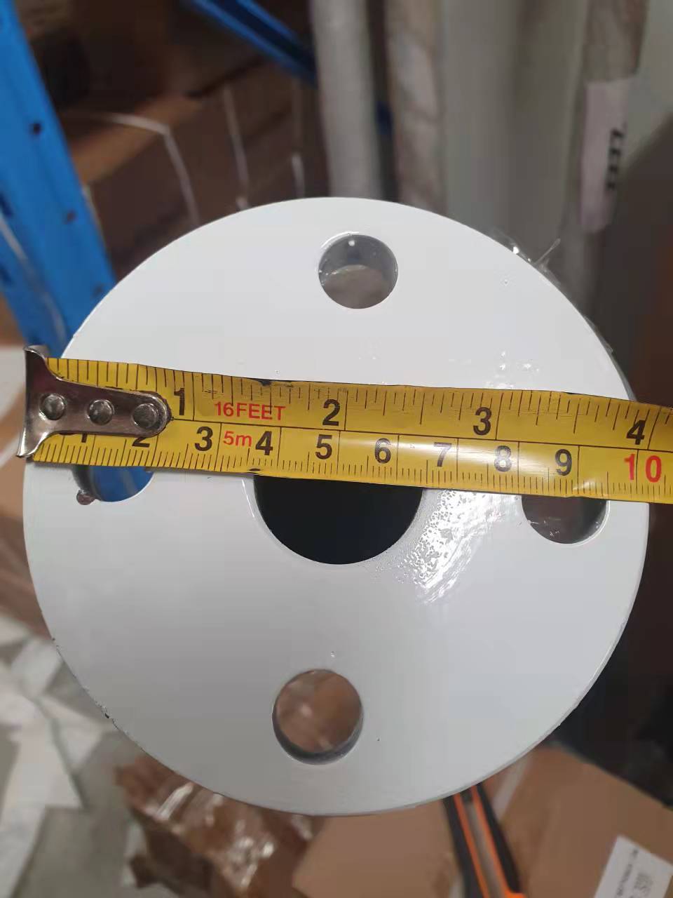 Wind turbine pole 15m leaning against wall for size reference