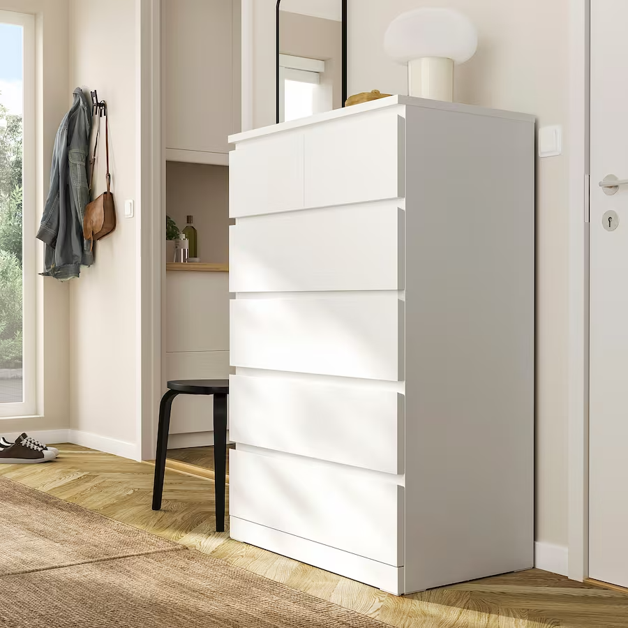 Half-sized drawer open in tall boy drawers showing storage depth