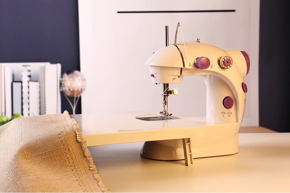 Mini sewing machine showing handwheel and thread winding mechanism