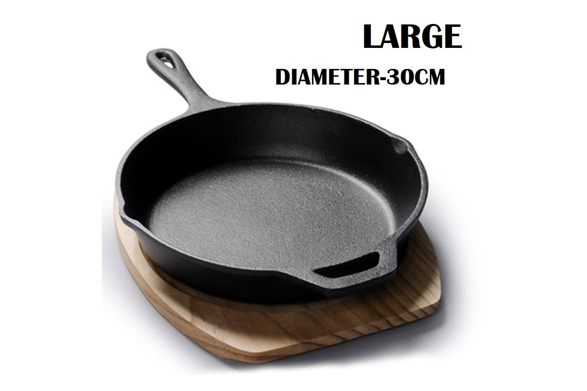 Side angle of cast iron frying pan skillet showing helper handle