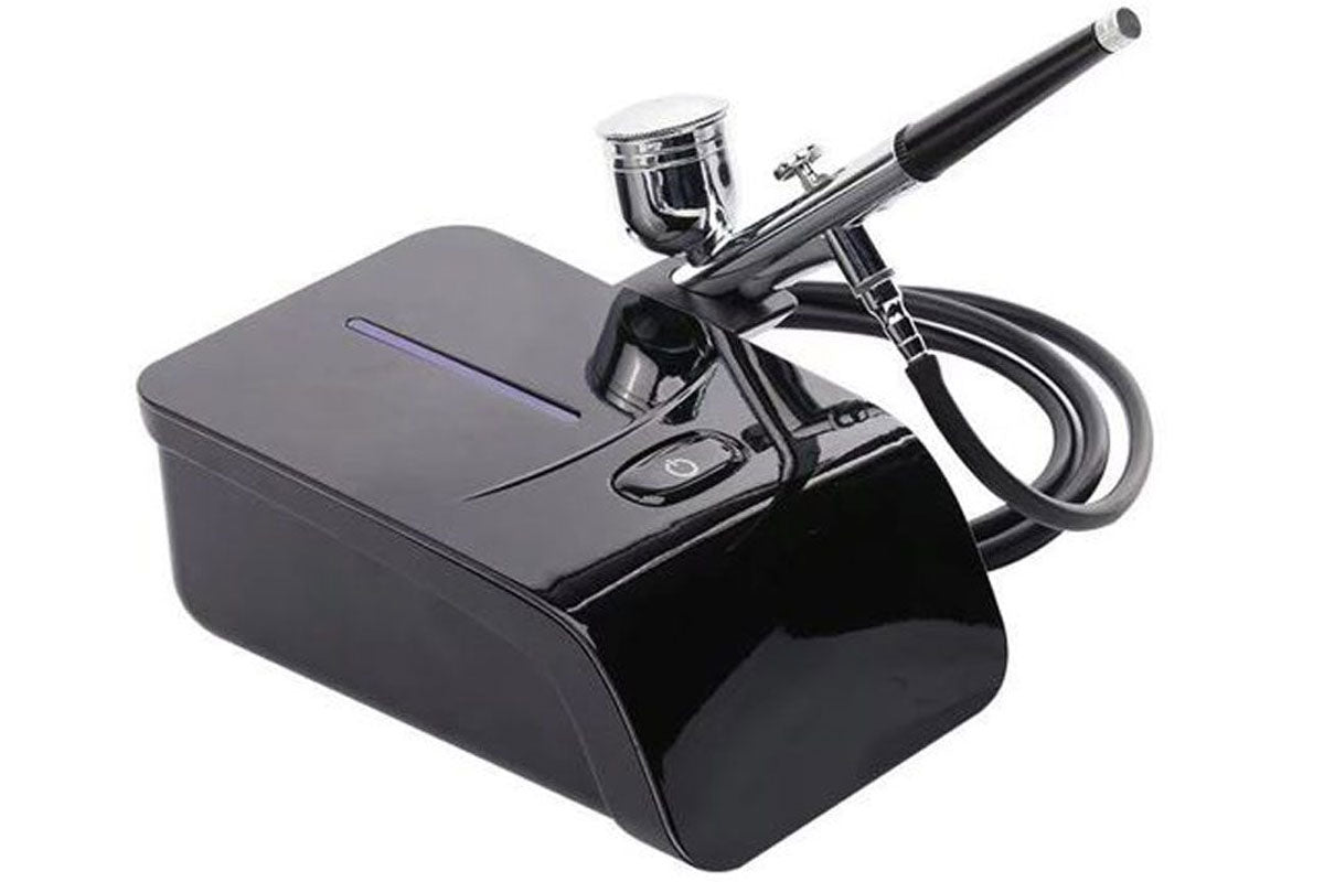 Side view of air brush compressor with ergonomic design