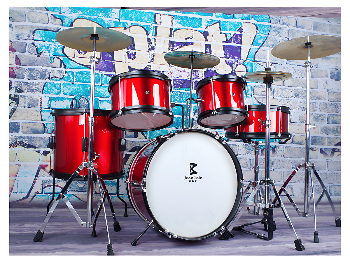 Side view of red kids drum kit set with cymbals