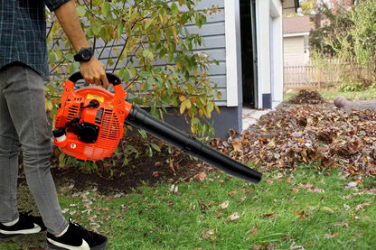 Lightweight petrol leaf blower resting on grass
