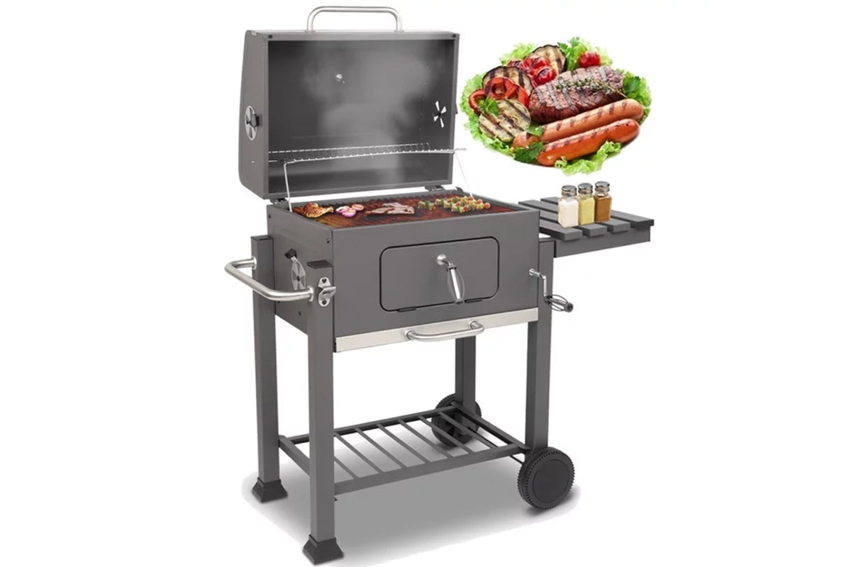 Side view of charcoal BBQ grill with foldable shelf
