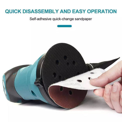 Orbital sander polishing wood surface in workshop