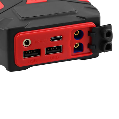 Car jump starter connected to car battery with jump leads