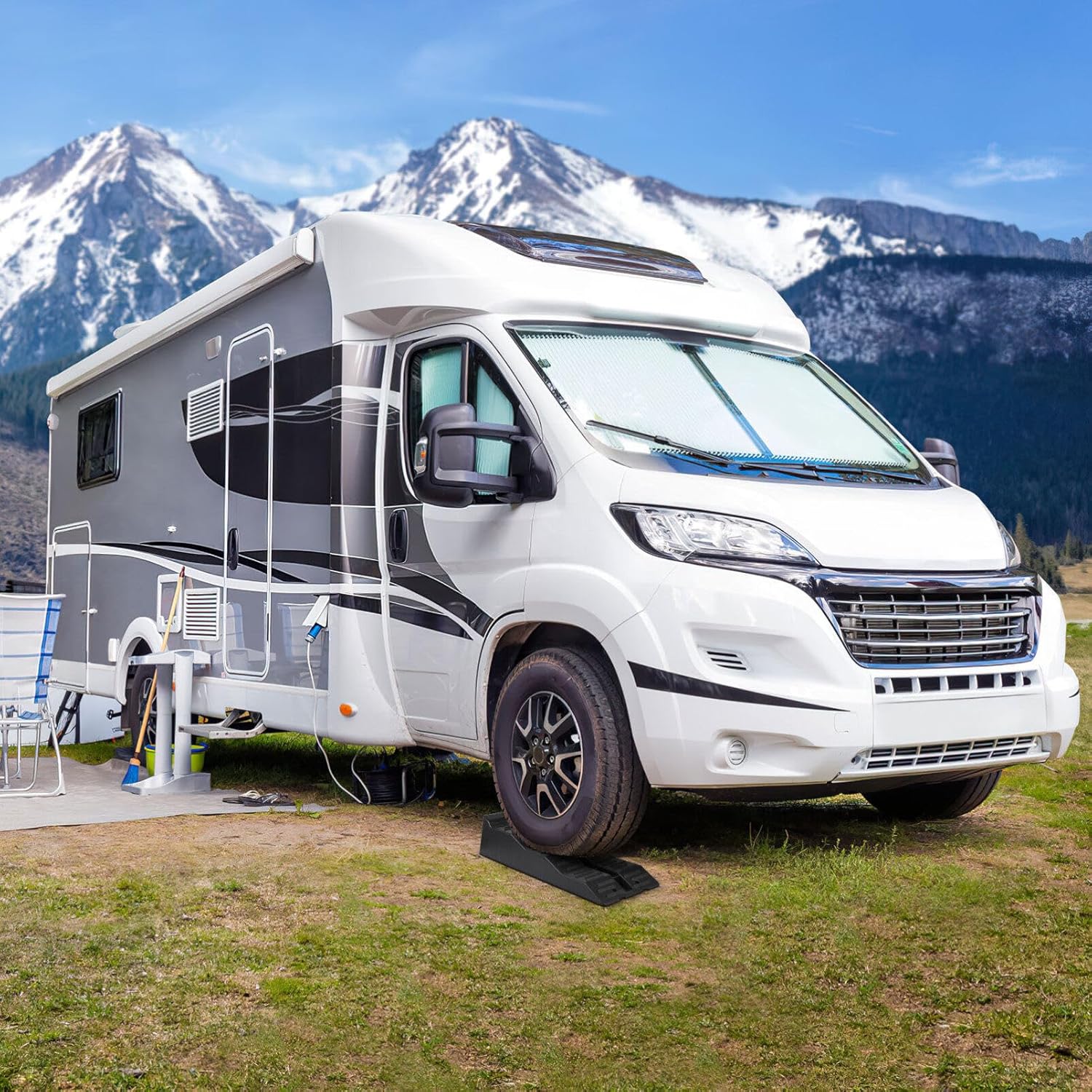 Camper wheel chocks placed under caravan tyre for stability