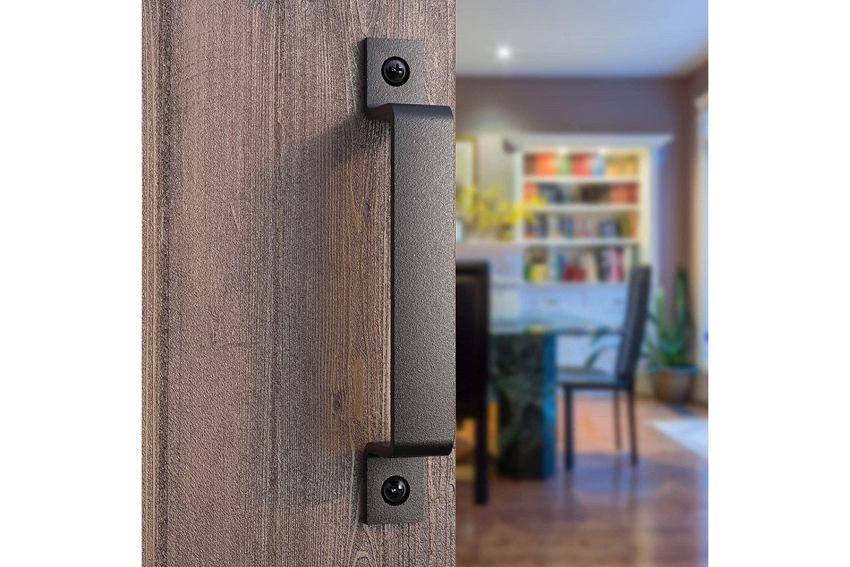 Black steel barn door handle mounted on exterior gate