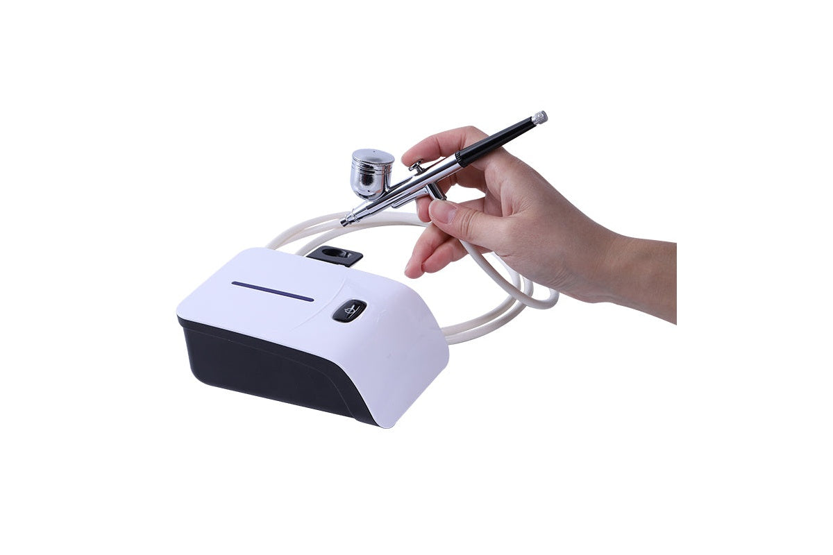 Close-up of air brush compressor alloy body and trigger