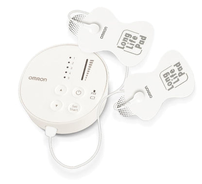 Omron TENS machine next to instruction manual and batteries