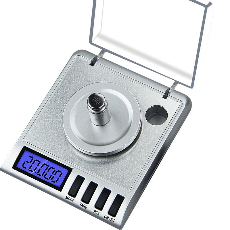 Digital scale 50g x 0001g showing blue backlit LCD screen