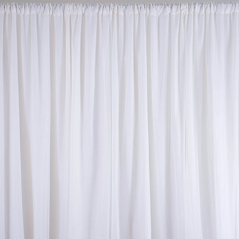White wedding backdrop curtain hanging in event space