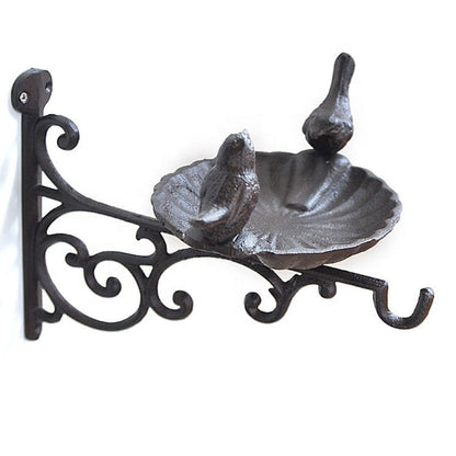 Cast iron rustic brown bird bath showing two perched birds detail