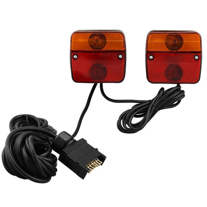 Trailer tail lights showing red lens and 7 pin plug connection