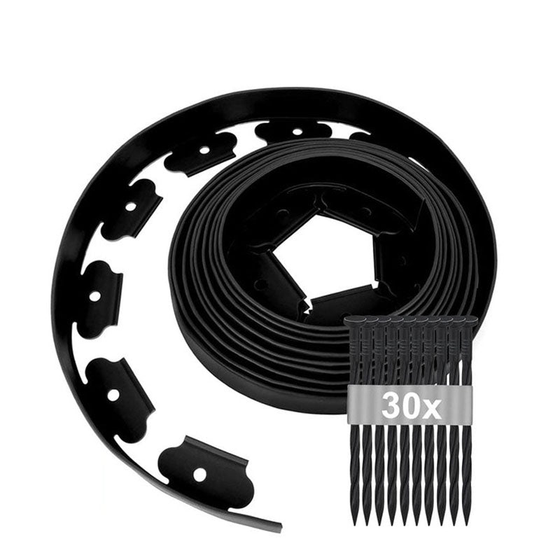 Garden lawn edging black flexible roll laid out on grass