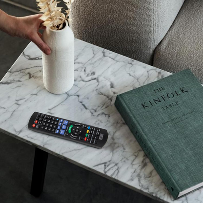 Replacement remote for Panasonic Blu-ray disc resting on wooden table
