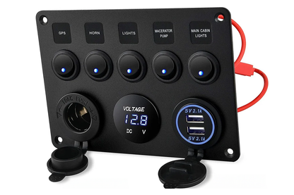 Close-up of rocker switch panel USB ports in black aluminium