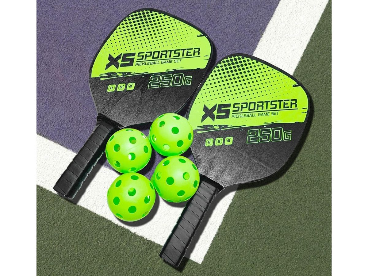 Pickleball set displayed with paddles crossed and balls in front