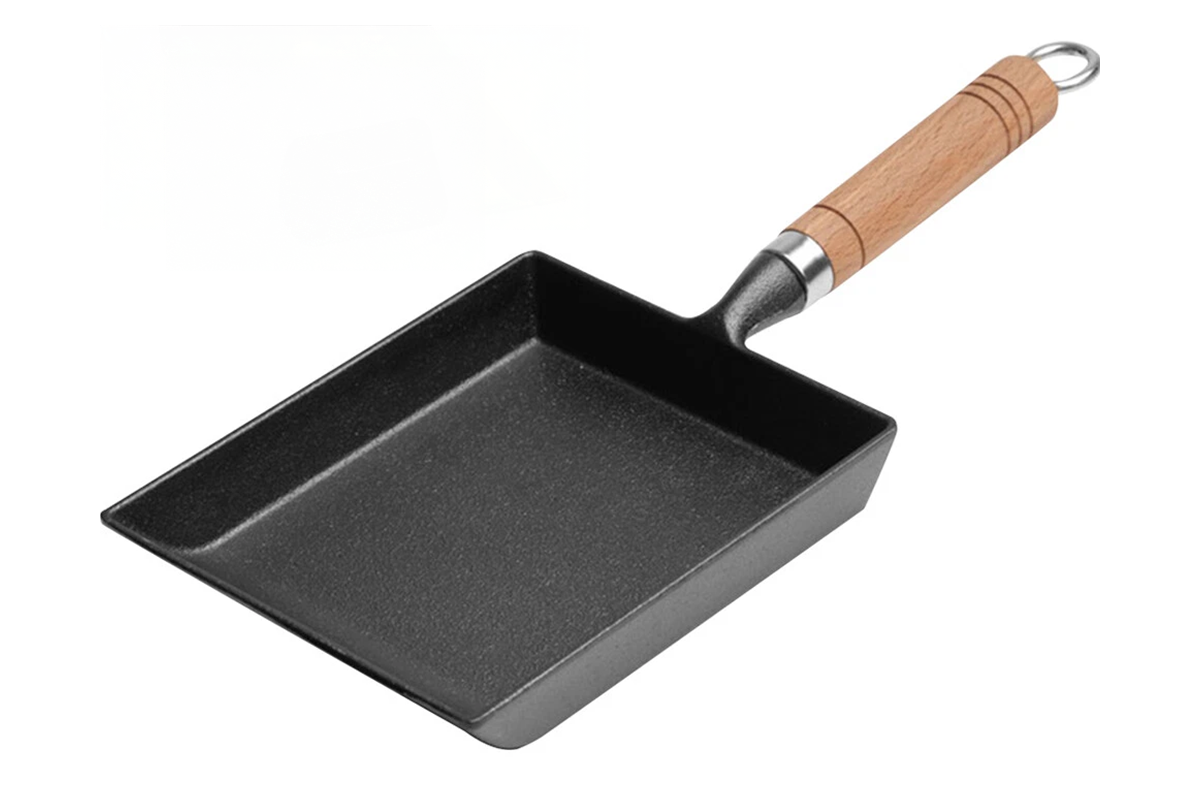 Side angle of cast iron frying pan square with wooden handle
