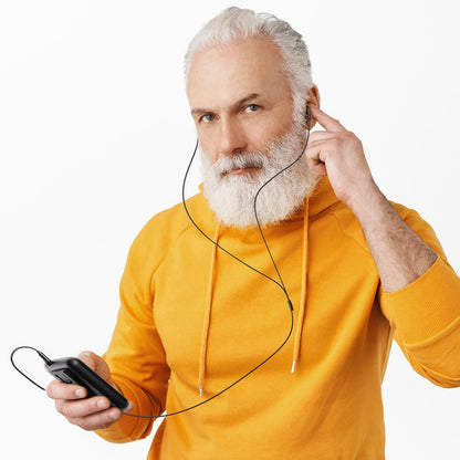 Ear hearing aids device in black colour resting on a flat surface