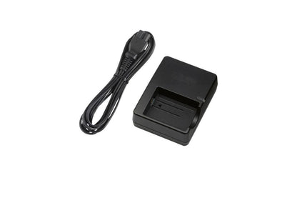 Side angle of Canon LP-E5 battery charger with NZ power cord attached