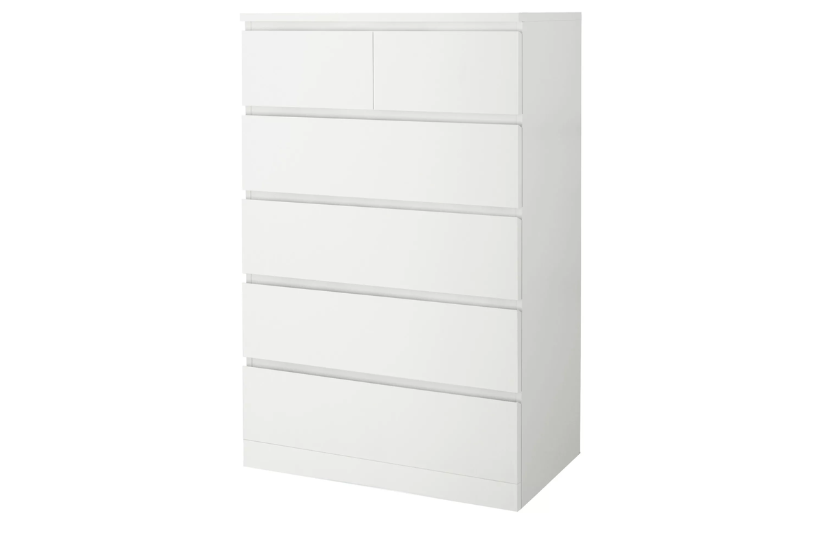 Close up of white particle board material on tall boy drawers