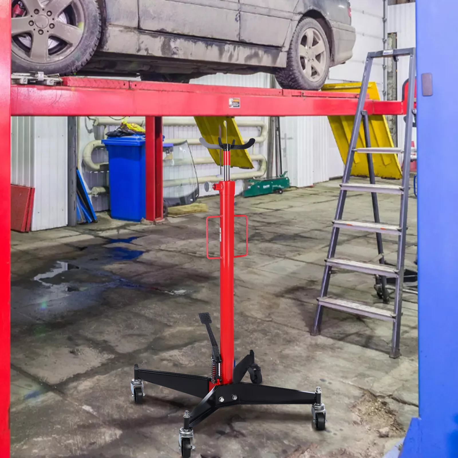 Transmission jack lifting a vehicle component in workshop