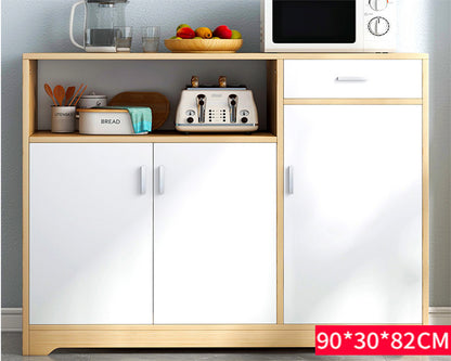 Open door of kitchen cabinet drawer revealing storage shelves