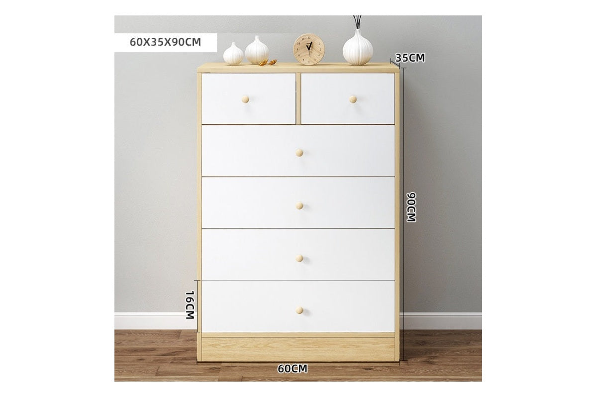 Close up of drawer handles on white tallboy chest of drawers