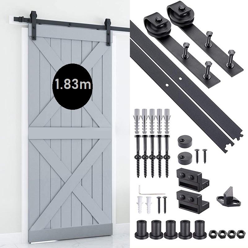 Barn door hardware mounted on wooden door panel in black finish