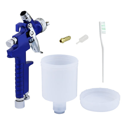Paint spray gun spraying wall paint in a home setting