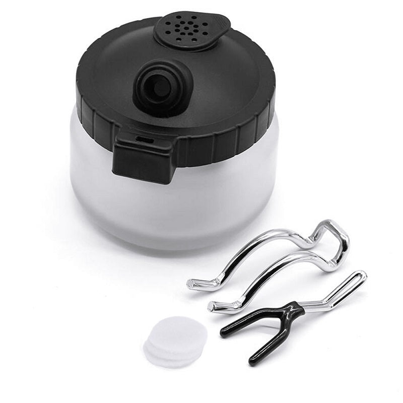 Airbrush cleaning pot showing anti-tip metal handle design