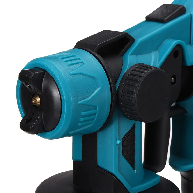 Paint sprayer gun held by user painting ceiling