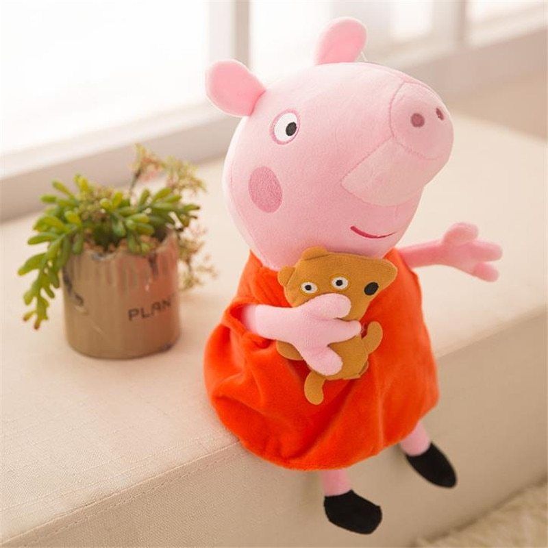 Peppa Pig doll soft toy held by a child showing size