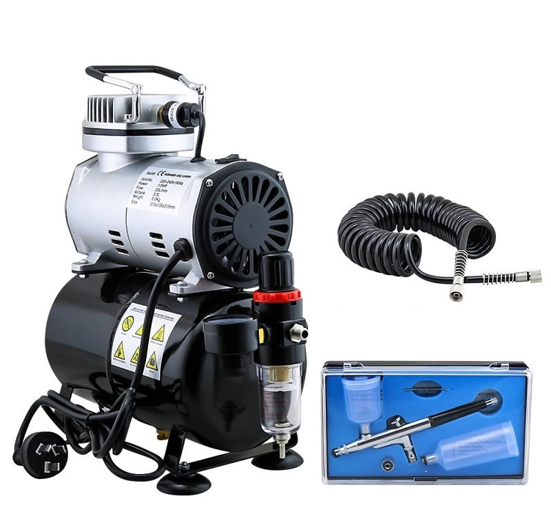 Air brush compressor connected to airbrush with hose attached
