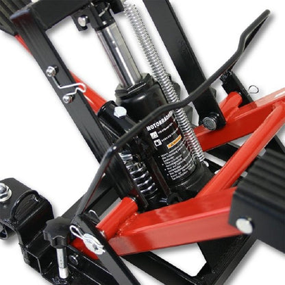 Motorcycle lifter jack in workshop setting lifting a quad bike