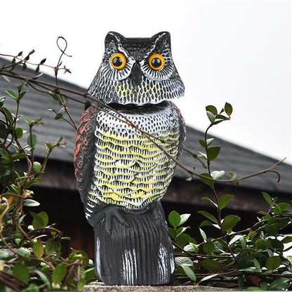 Side view of owl decoy bird scarer with sand filled base